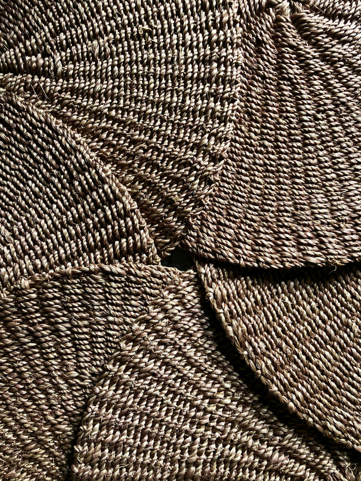 Round woven mats in brown and white