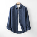 Indigo blue cotton shirt on a hanger