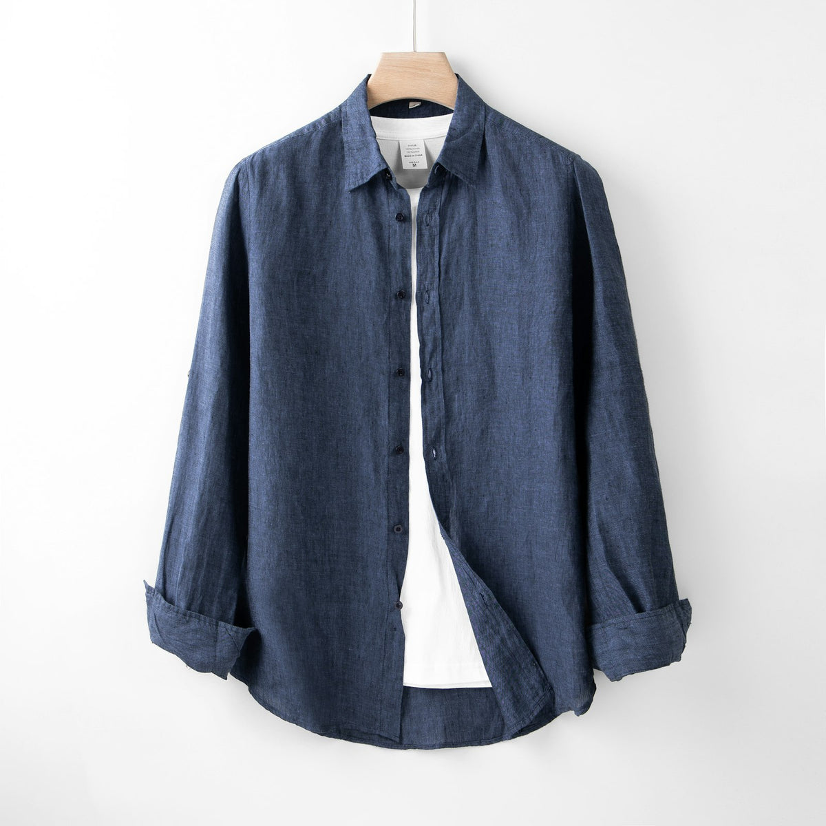 Indigo blue cotton shirt on a hanger
