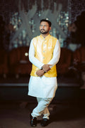 Man wearing a yellow Modi jacket over a white kurta