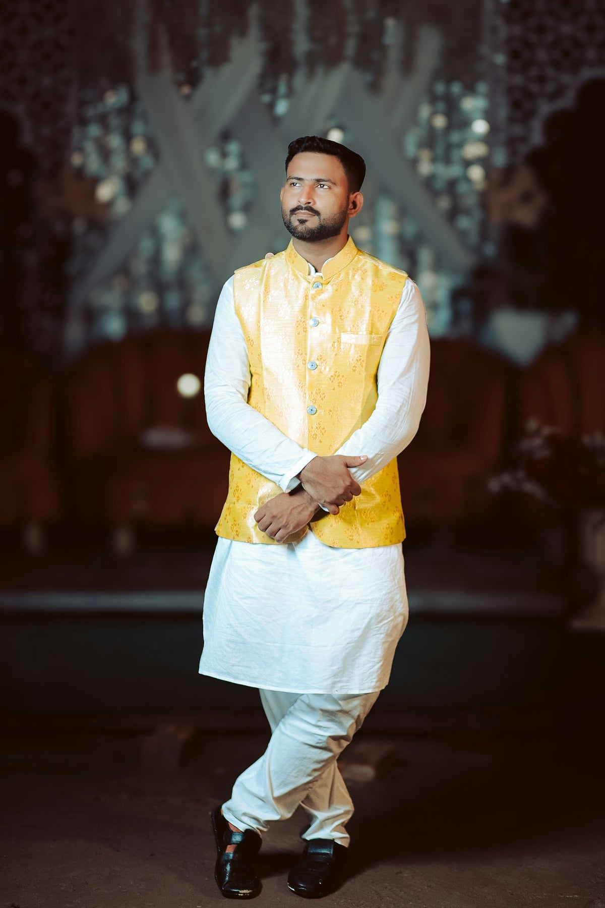 Man wearing a yellow Modi jacket over a white kurta