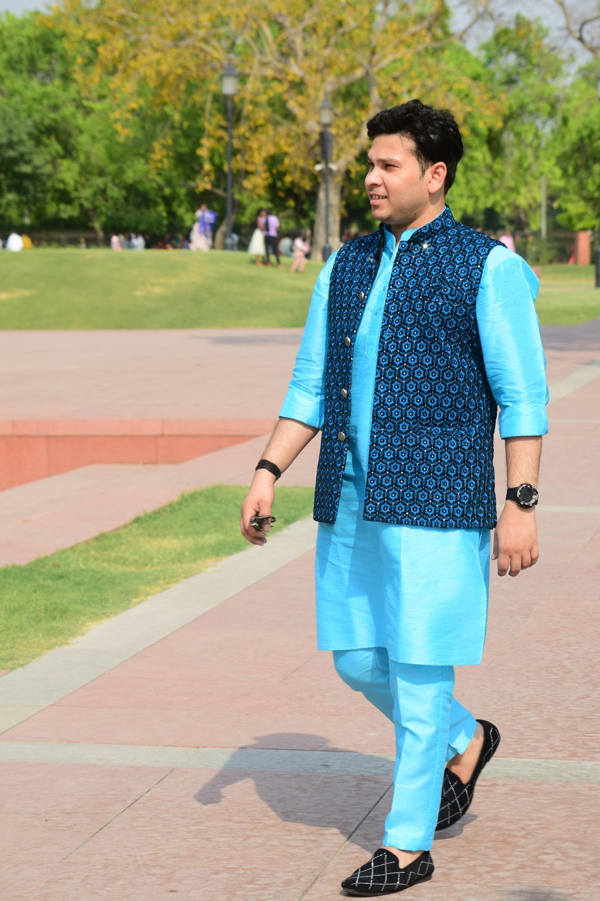Man wearing a patterned Nehru jacket over a kurta
